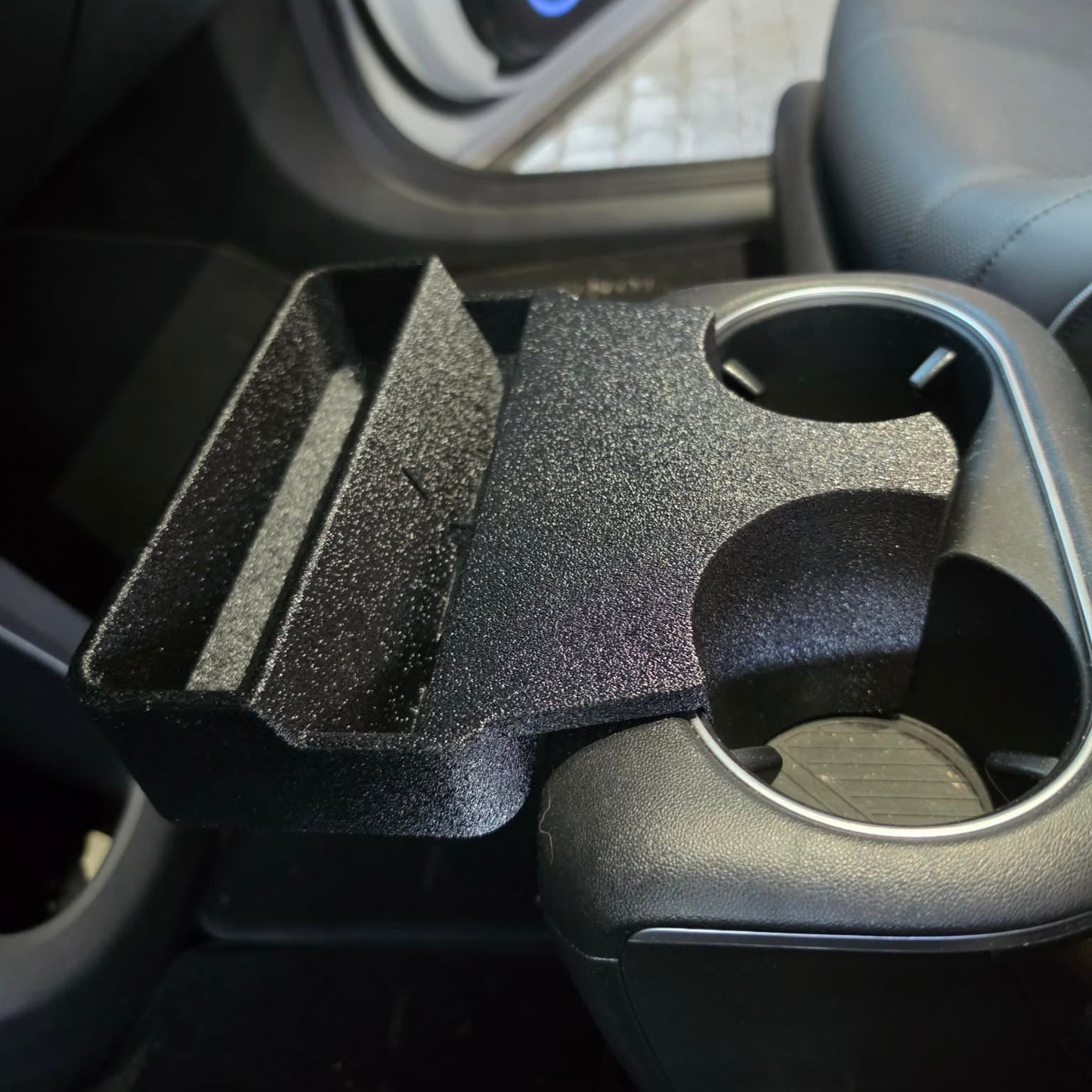 Close-up side view of Hyundai Ioniq 5 cup holder phone mount holding phone upright in portrait mode