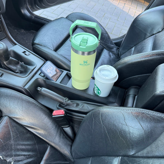 BMW E46 cup holder with wireless phone charger installed in center console