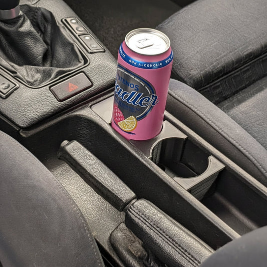 3D-printed BMW E36 cup holder installed in place of the ashtray, in use with a drink