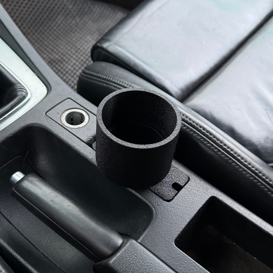 Audi A3 8P cup holder with a black cup in a vehicle interior