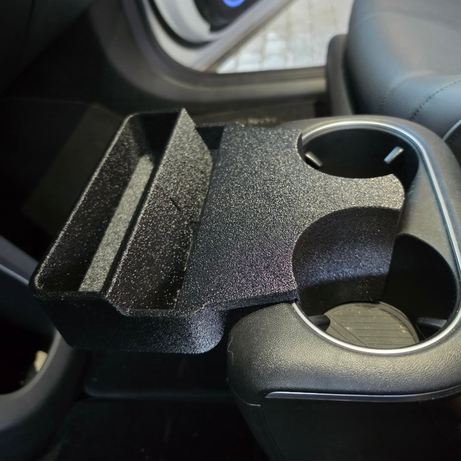 Close-up side view of Hyundai Ioniq 5 cup holder phone mount holding phone upright in portrait mode
